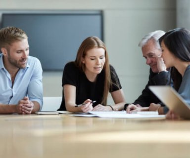 Business people reviewing paperwork in meeting